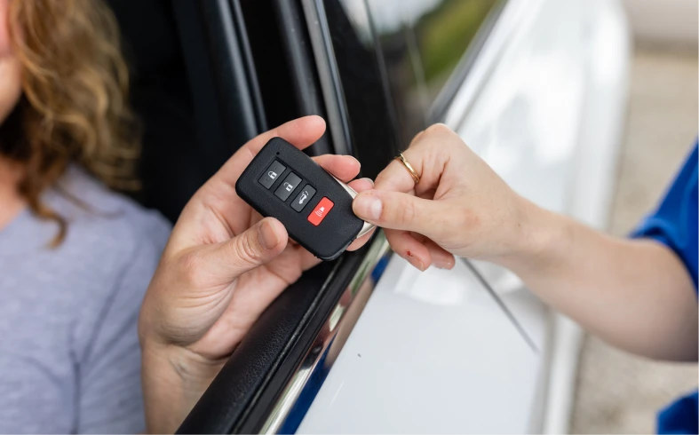 Handing car keys through car window